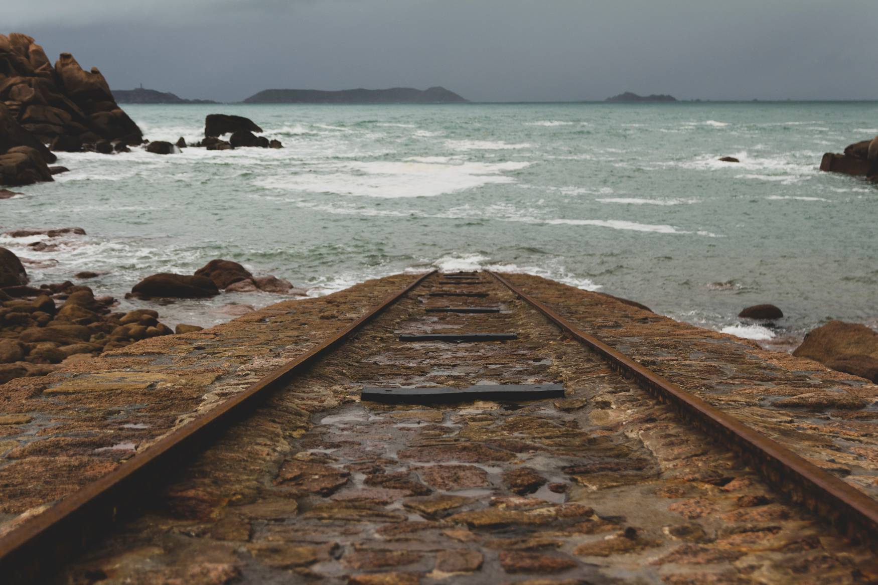 Train track going down into the ocean